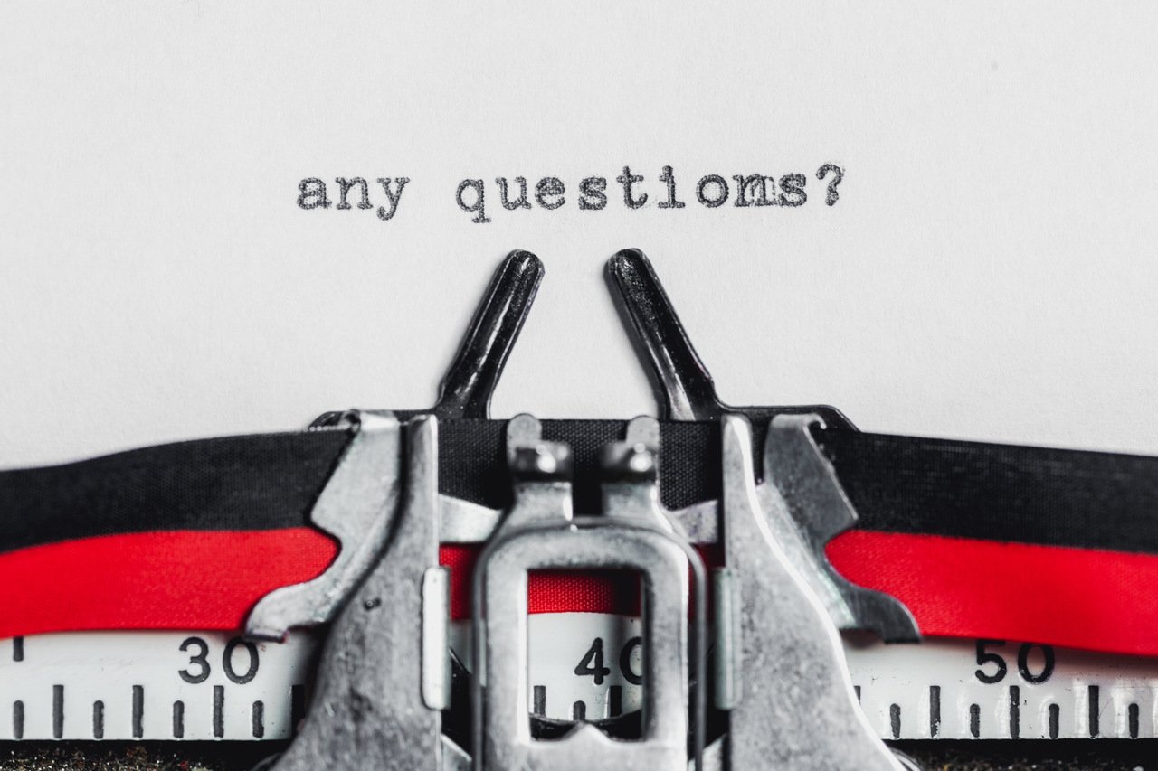 “any questions” written on a typewriter machine