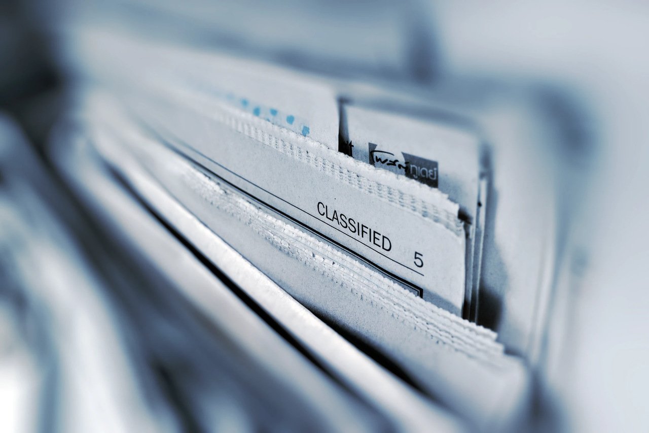 a stock photo showing paper folders stuffed together with one name visible as "classified 5"