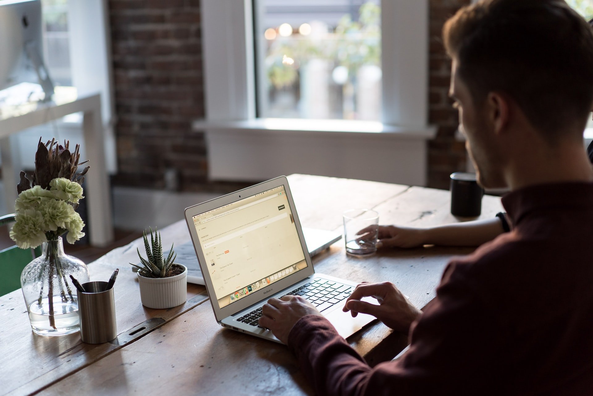 a man working with a laptop in an office