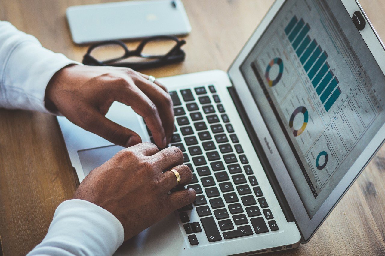 status page and a man's hands typing