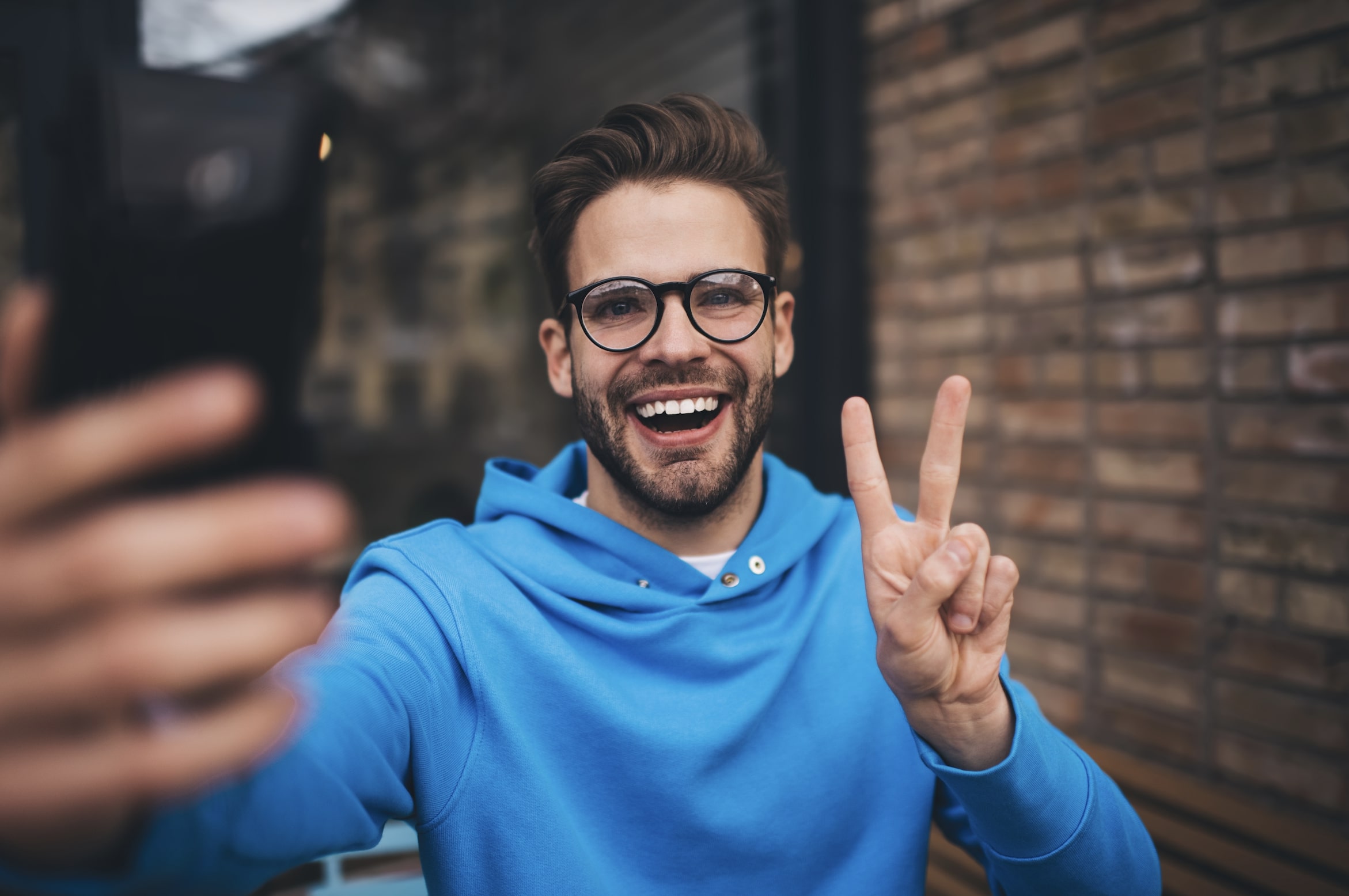 man-smiling-while-taking-a-selfie