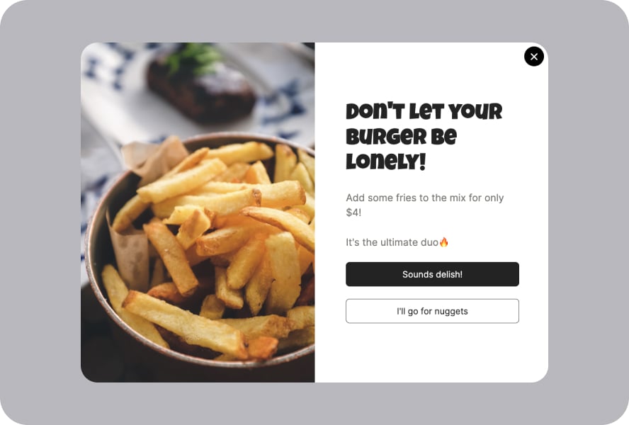 A lightbox popup with fries on the left and a text offering fries on the right followed by two buttons ad “Sounds delish!” and “I’ll go for nugget”