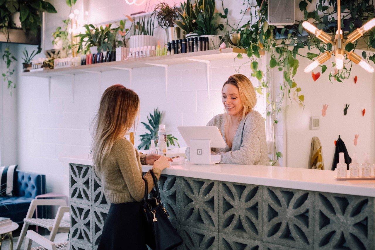 two women speaking and shopping