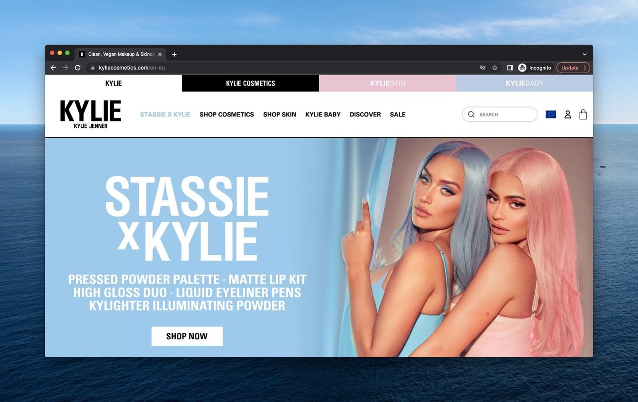 Kylie with pink hair and Stassie with blue hair hugging each other promoting the Kylie Cosmetics with the announcement explanations of the collaboration