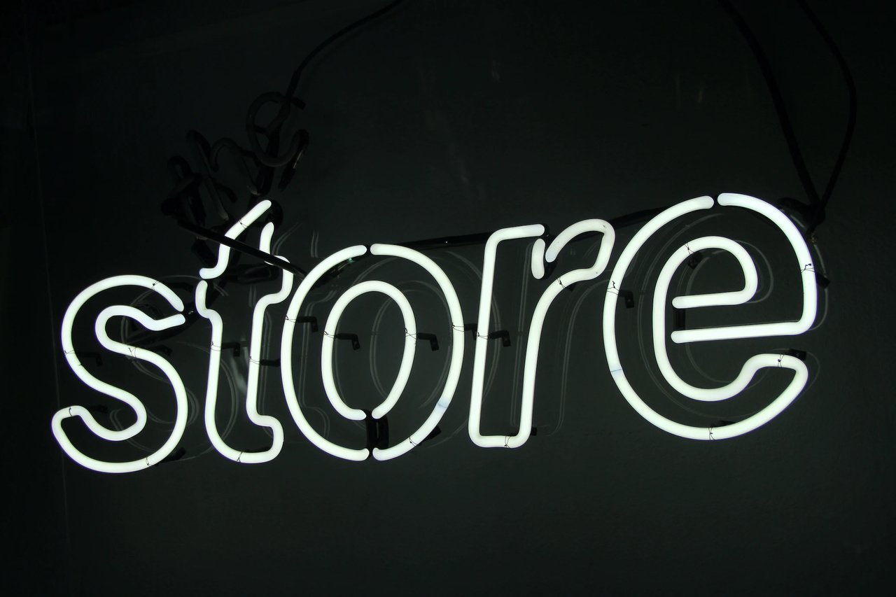 store written neon lights on a dark background at dark