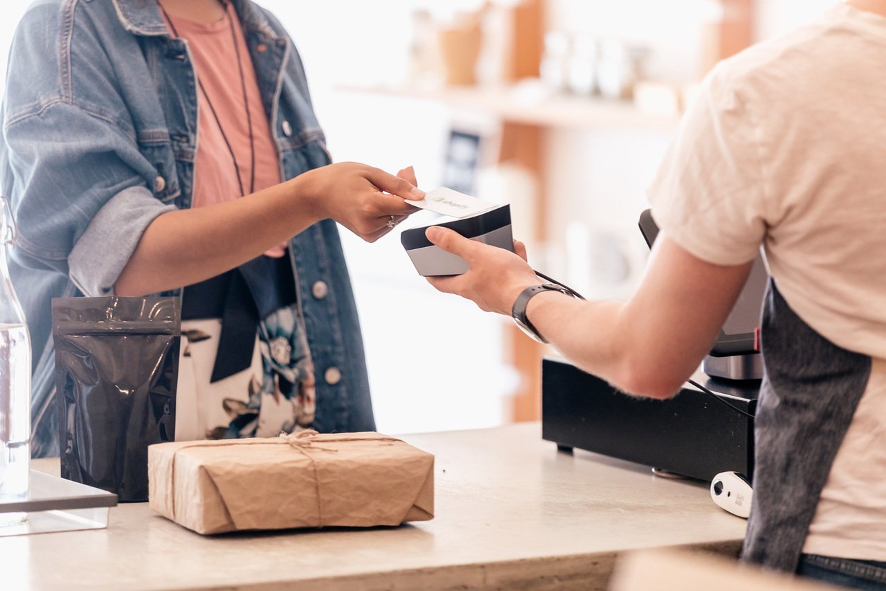 a woman paying for the products she bought with a credit card