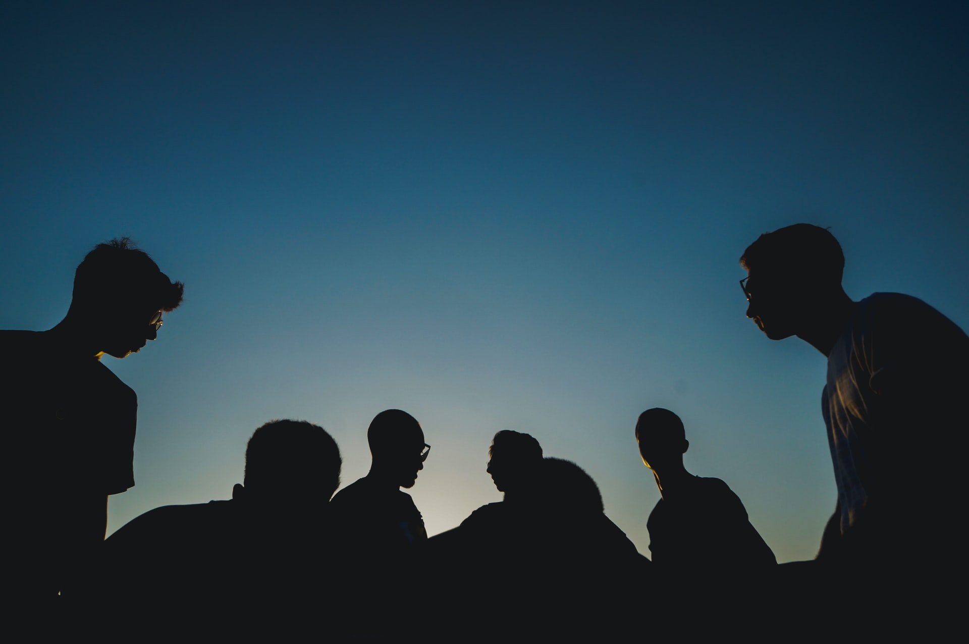 silhouttes of people talking to each other