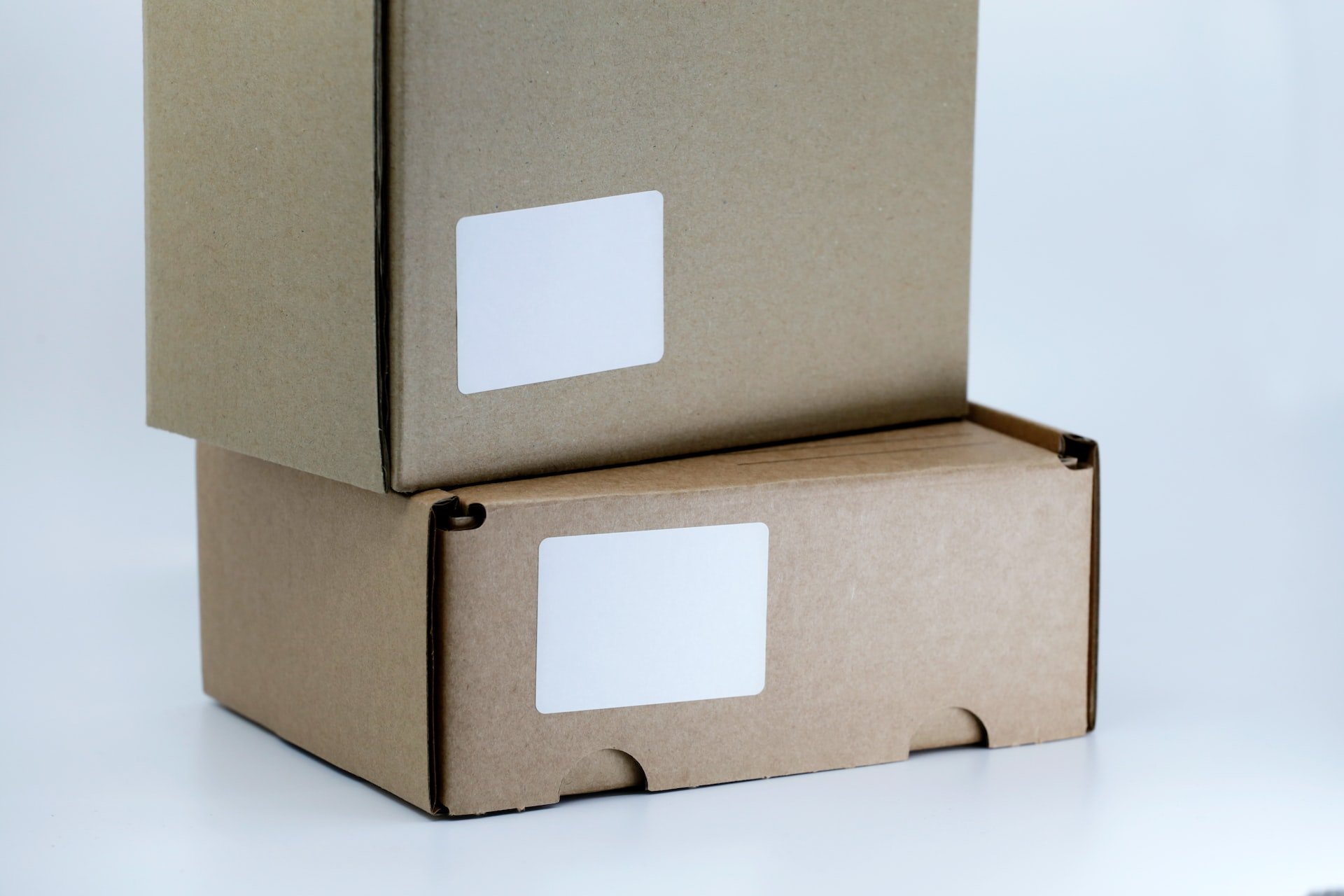 two brown cardboard boxes with a white background