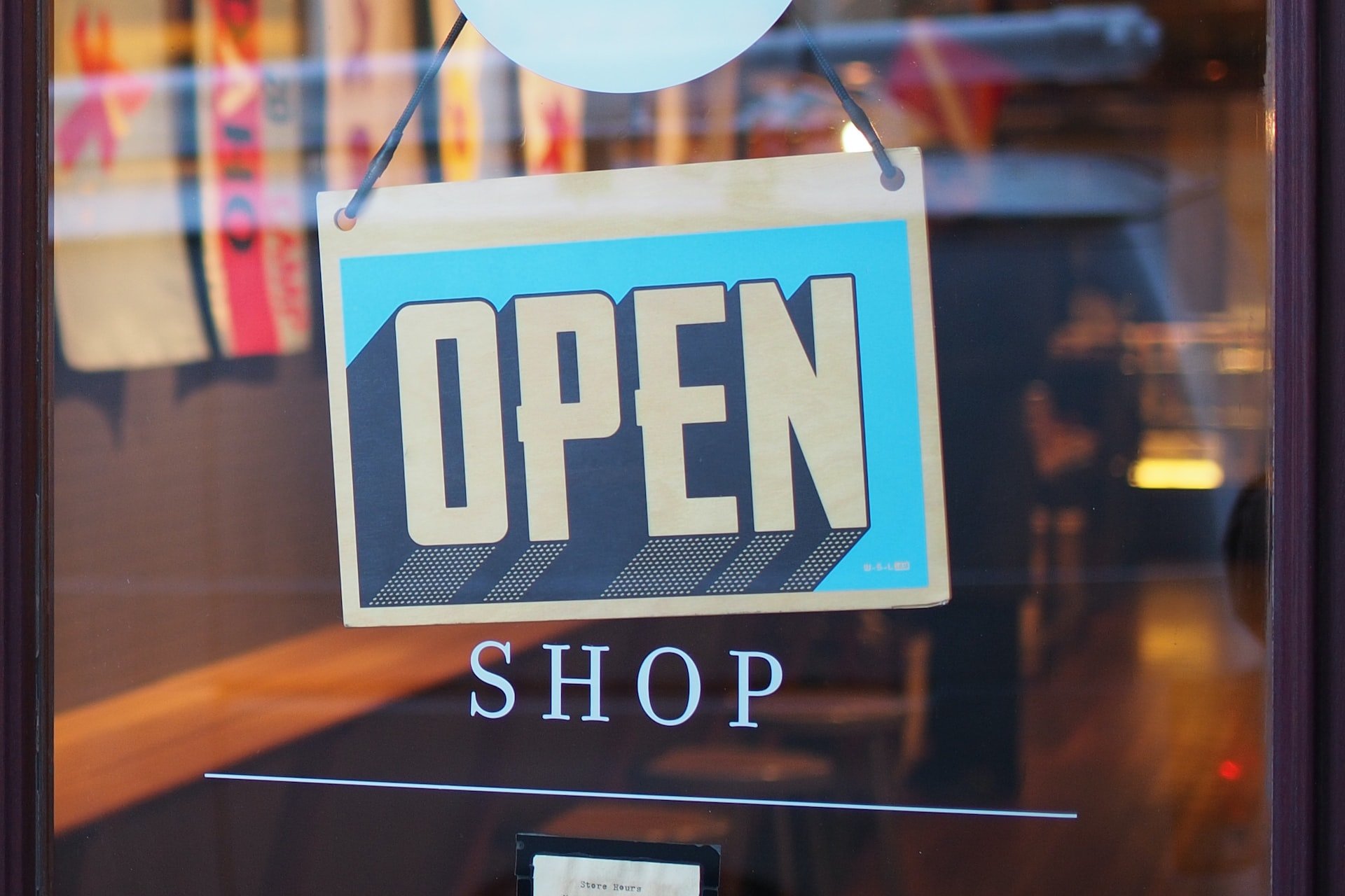 gray and blue coloured open and shop signs on a store's door