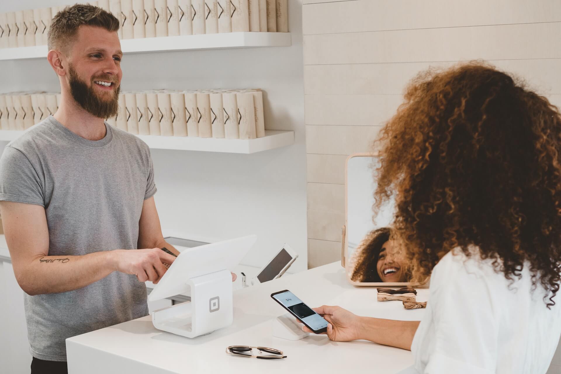 a man smiling to a woman on the counter