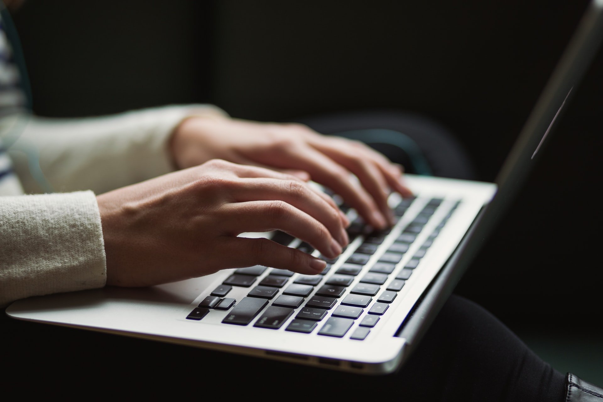 a person typing something on a MacBook keyboard