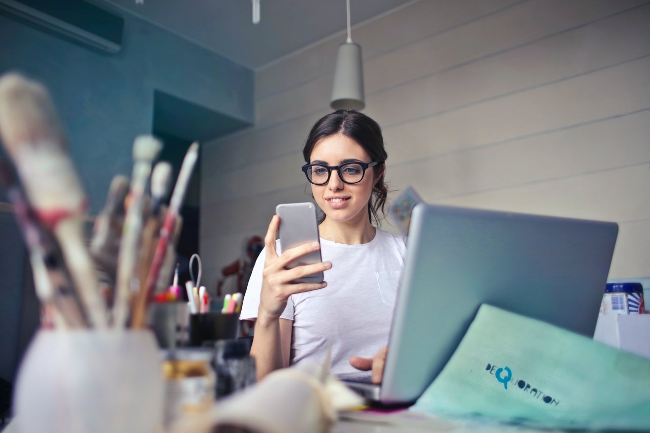 a woman with glasses opening an email