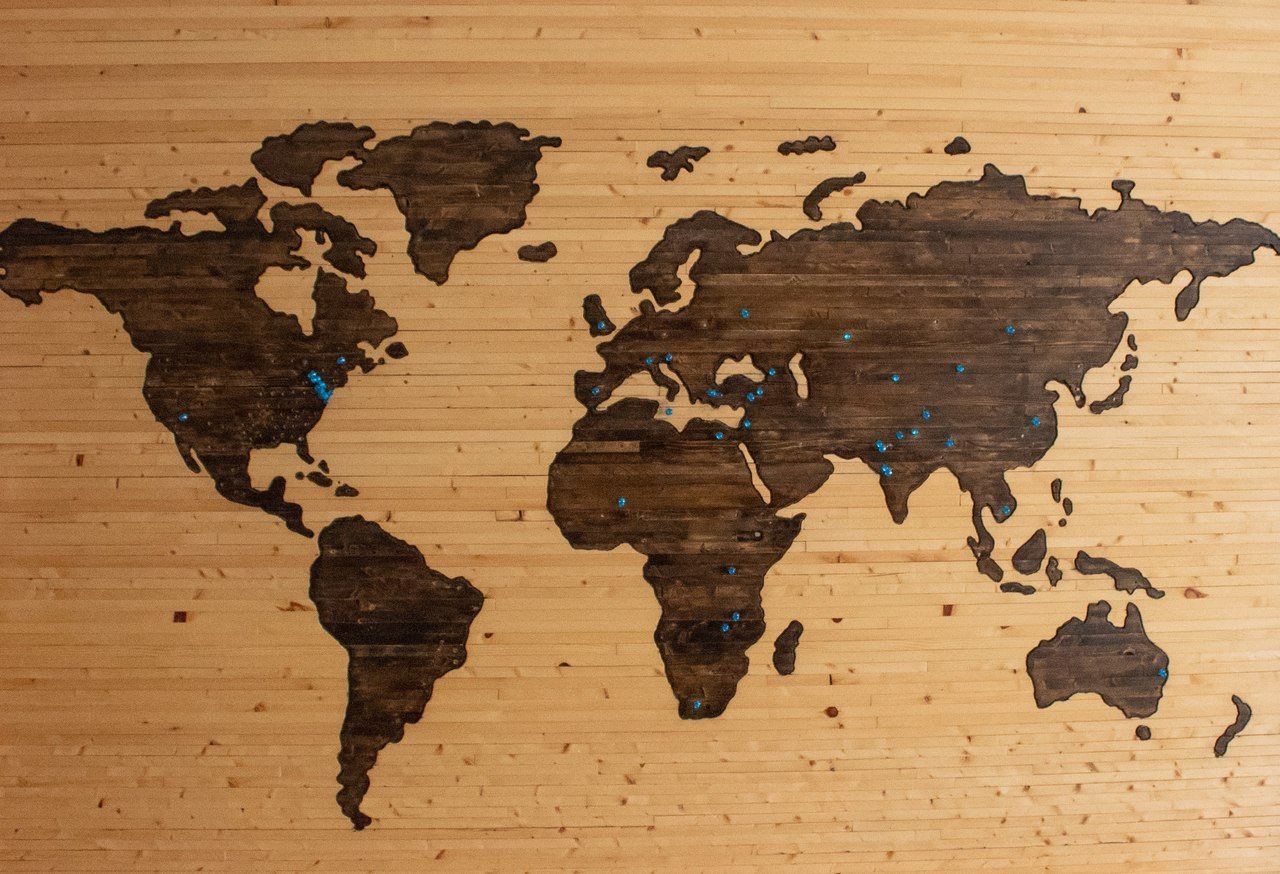 a picture of a wooden world map showing the whole world on a flat wooden screen