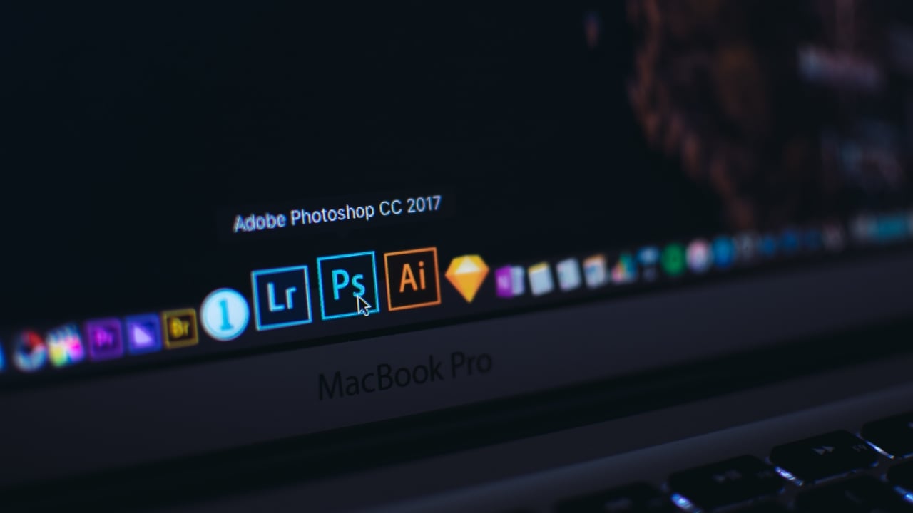 Adobe Photoshop logo shown on a laptop screen