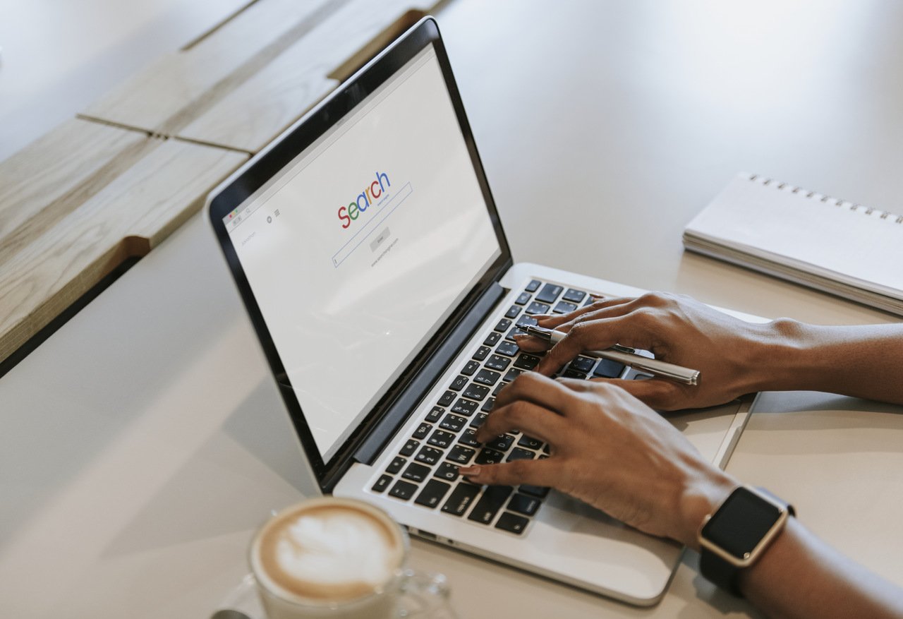 man typing on search engine on laptop