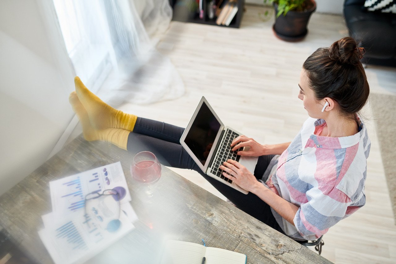 a woman sitting and writing blog on her computer