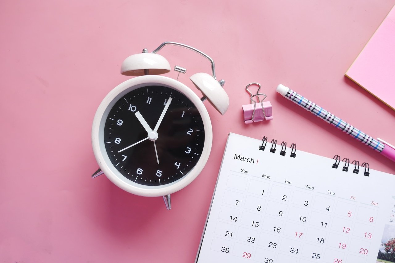 a clock and a calendar in pink-oriented image