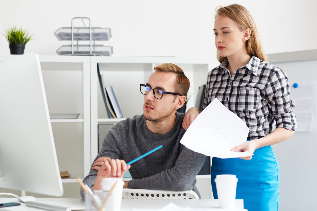 young colleagues looking at computer screen