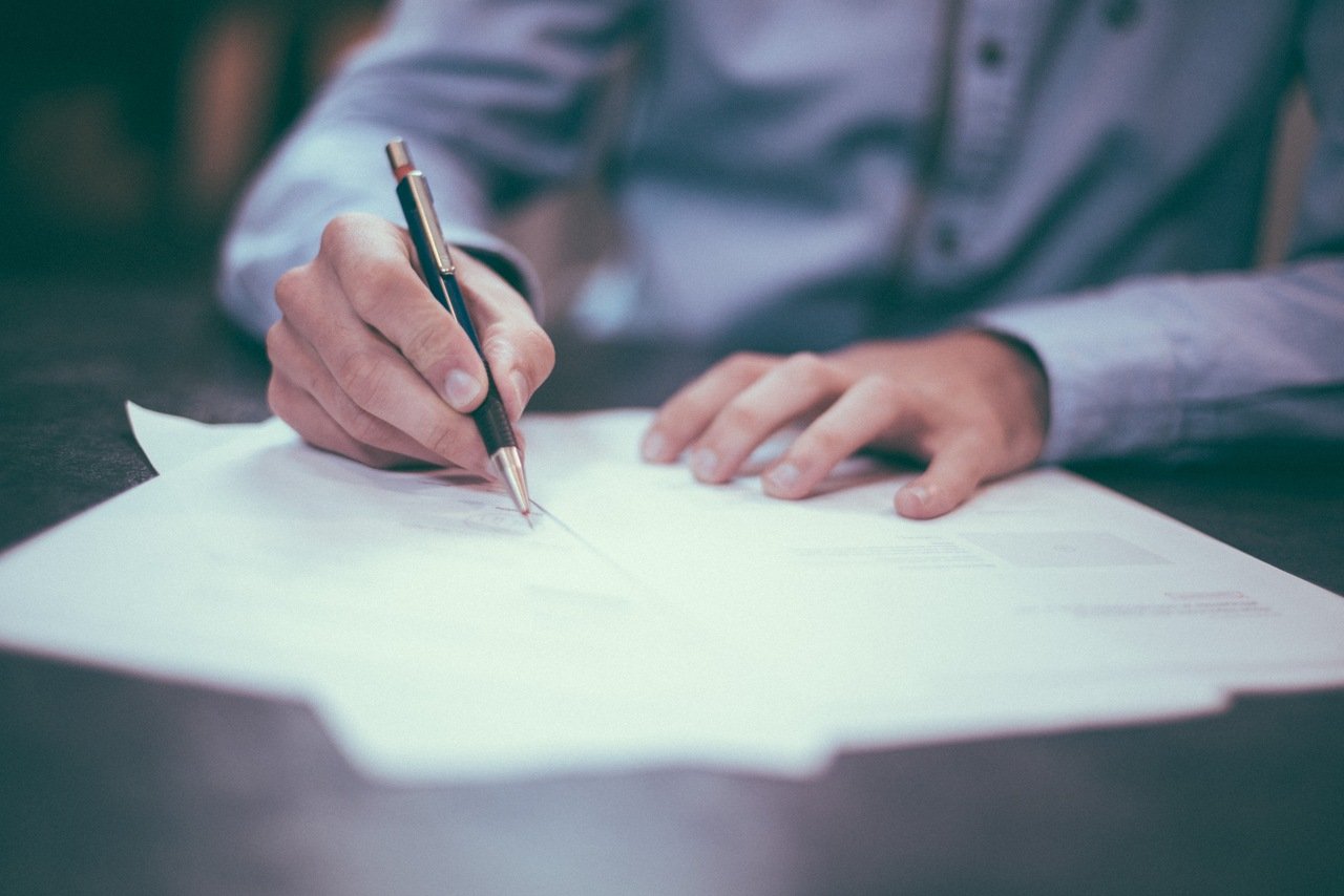 a man writing on a paper