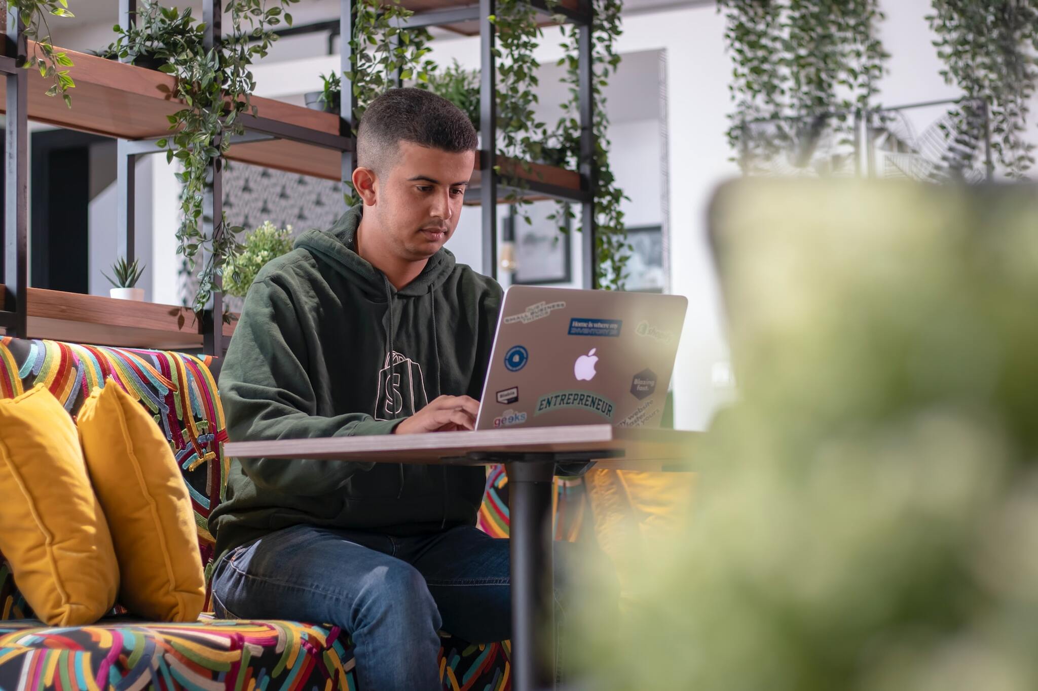 a man sitting on a couch with a laptop