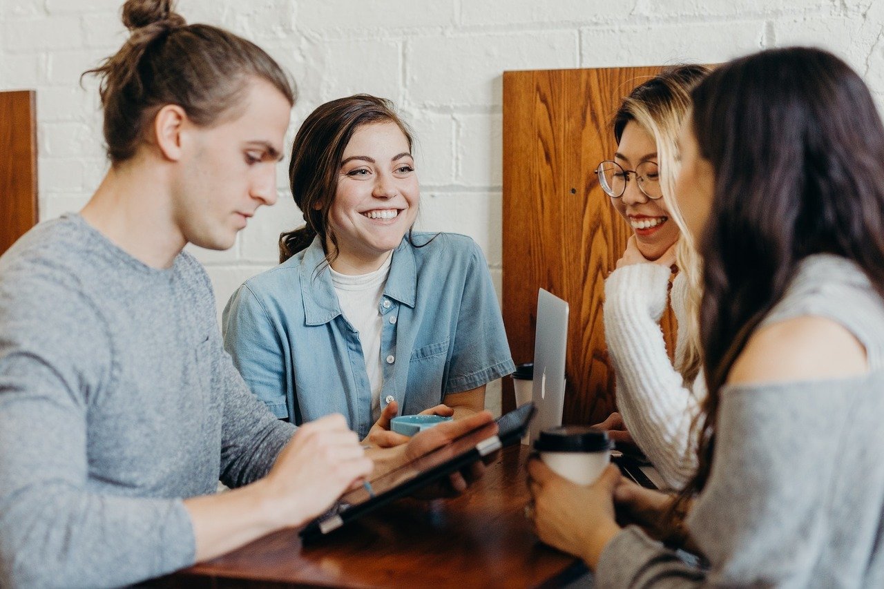 a group of people talking and smiling