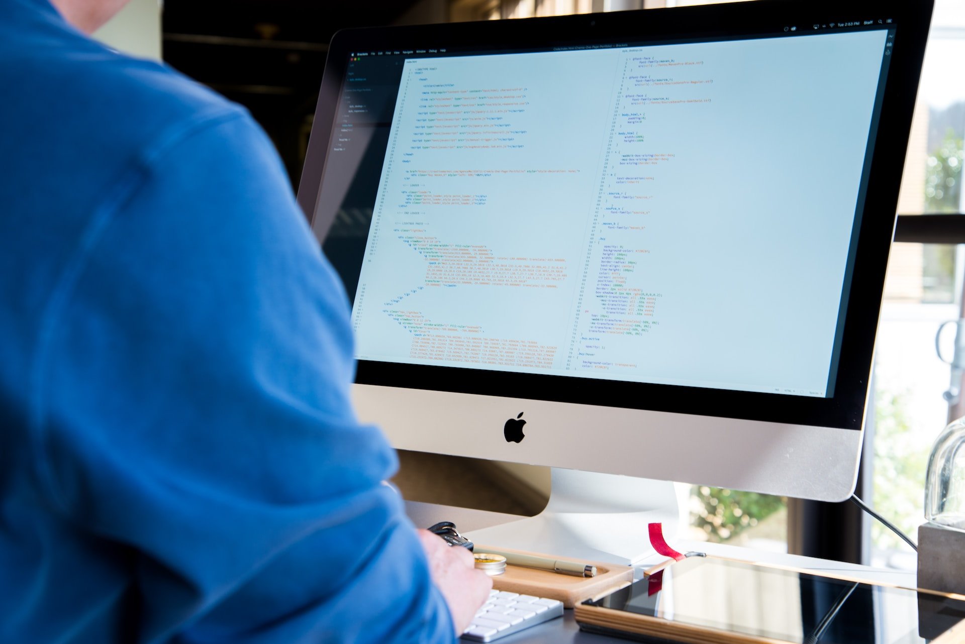 a person facing monitor while typing