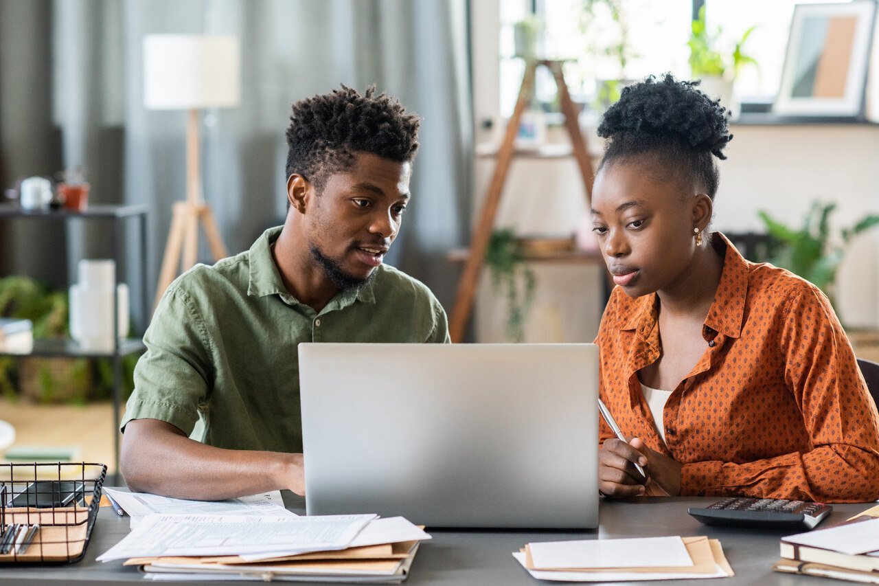 two people dealing with computer for sign-ups