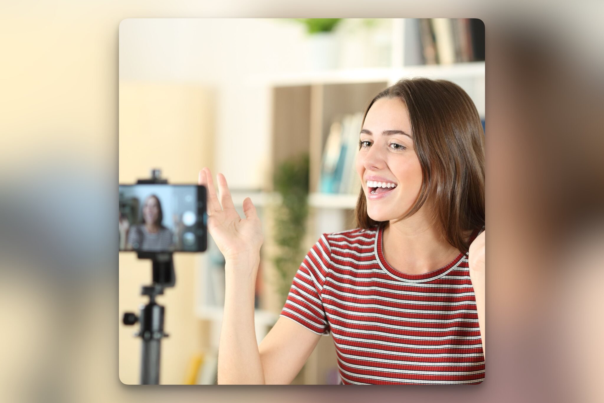 A female influencer recording herself on the camera, smiling