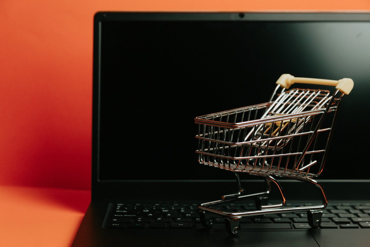 miniature shopping cart on a laptop keyboard