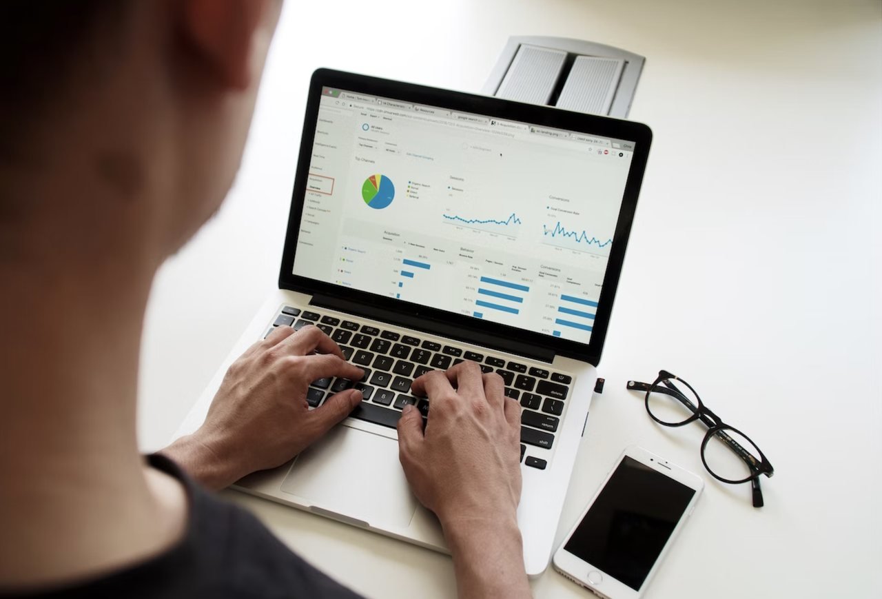 a man typing on his laptop and checking his website analytics