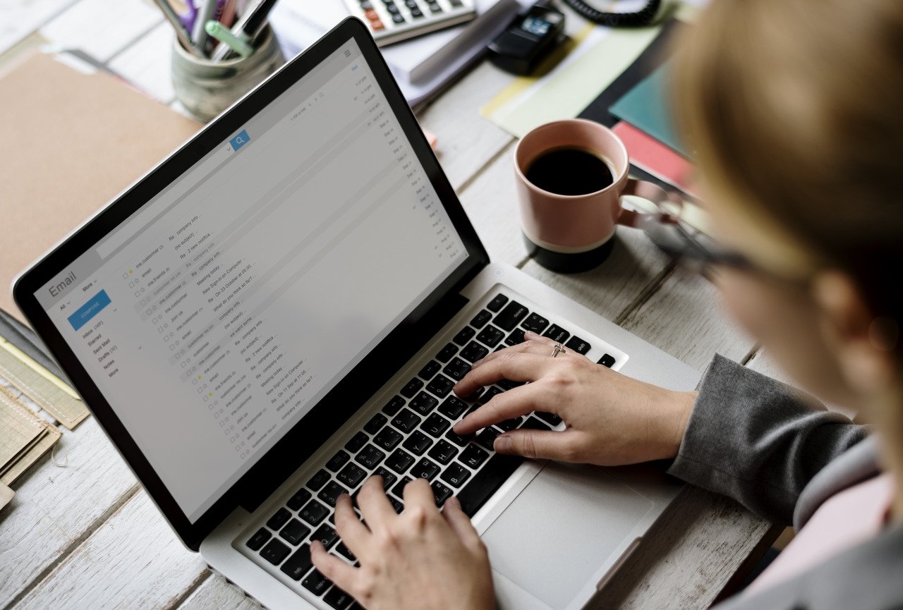 business woman checking emails on laptop