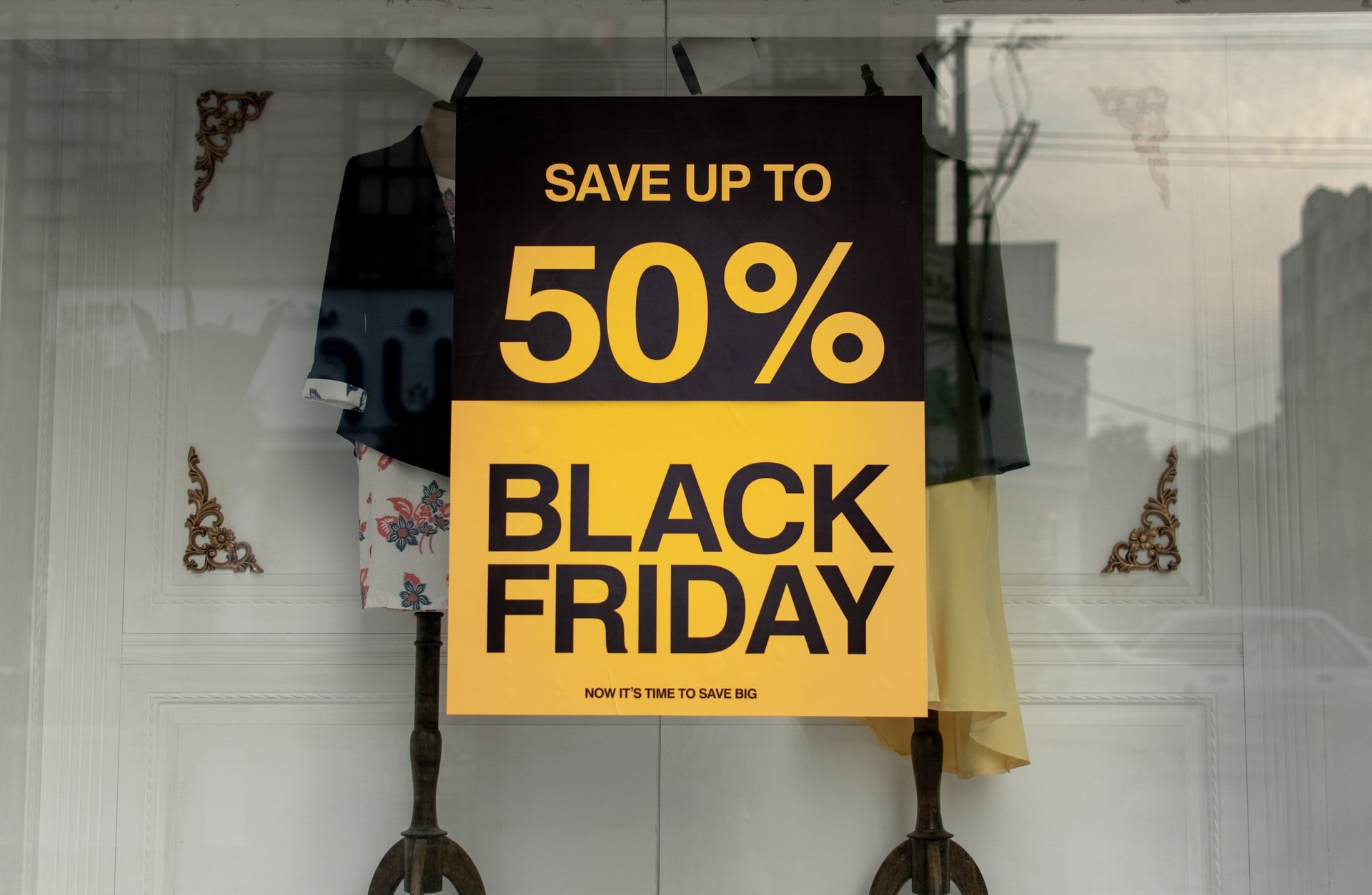 Black Friday poster that says "SAVE UP TO 50% BLACK FRIDAY" on a clothing store