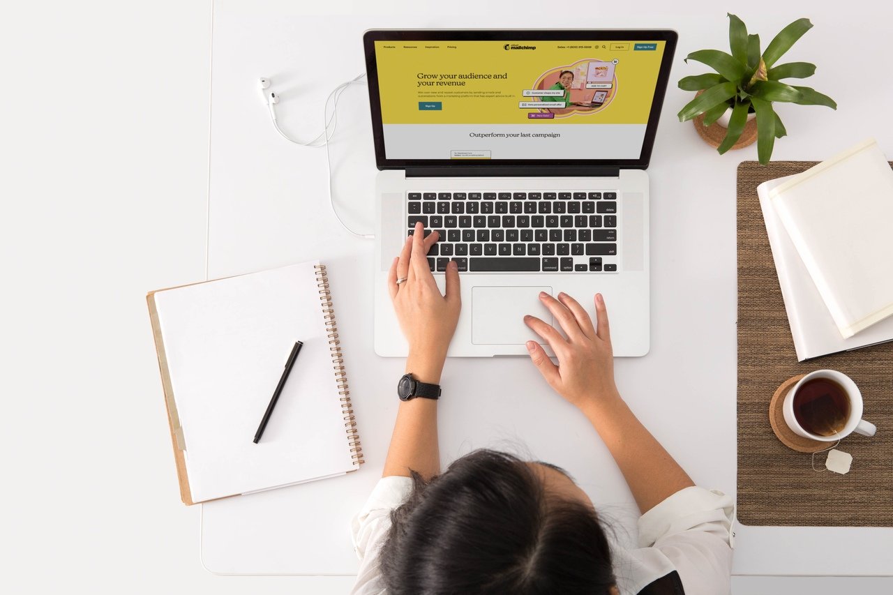 a woman searching the right content type on her laptop and there are notebook and a pencil to take notes