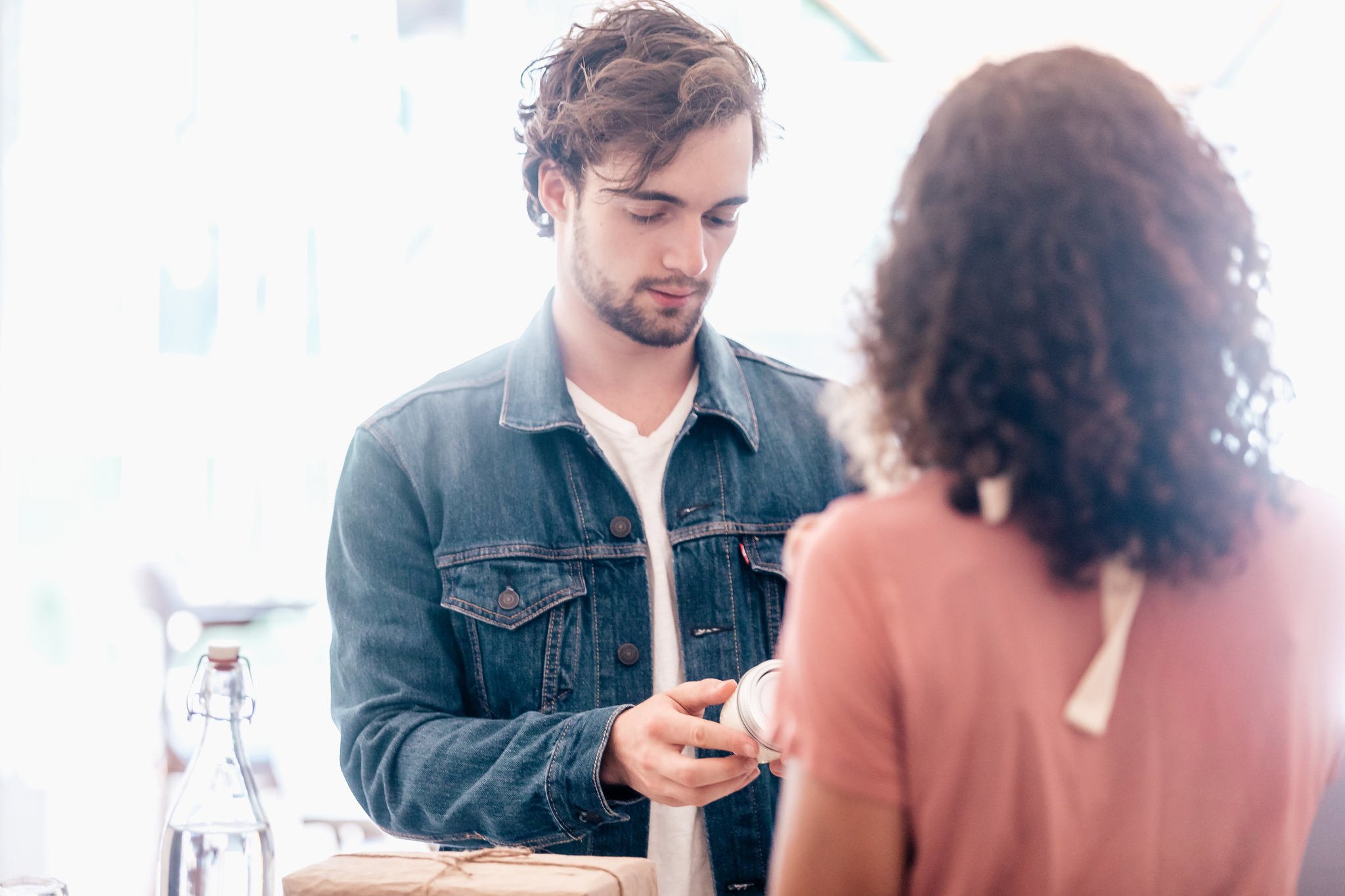 a man holding a product and a woman looking at him