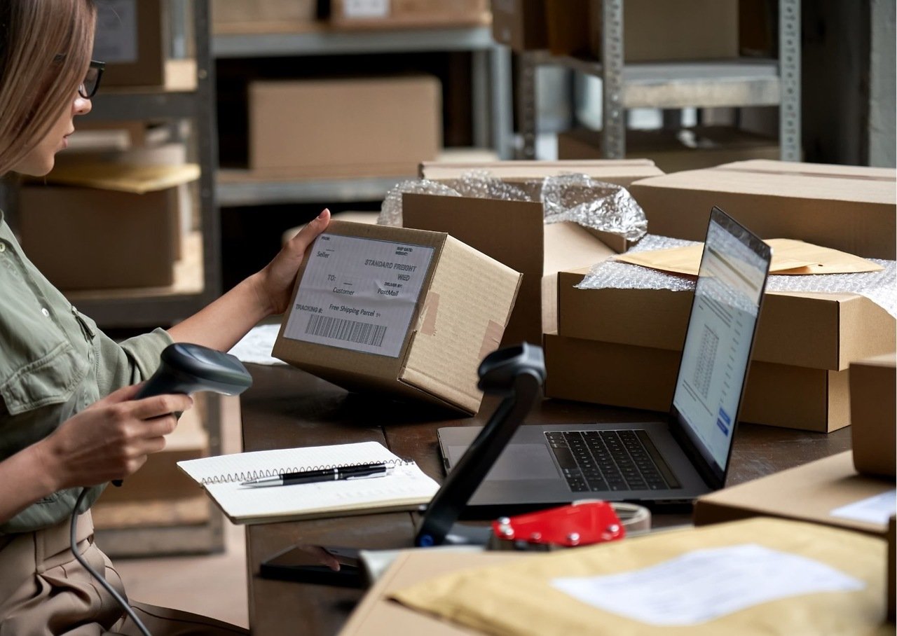 a woman with glasses checking the package what is written on for dropshipping