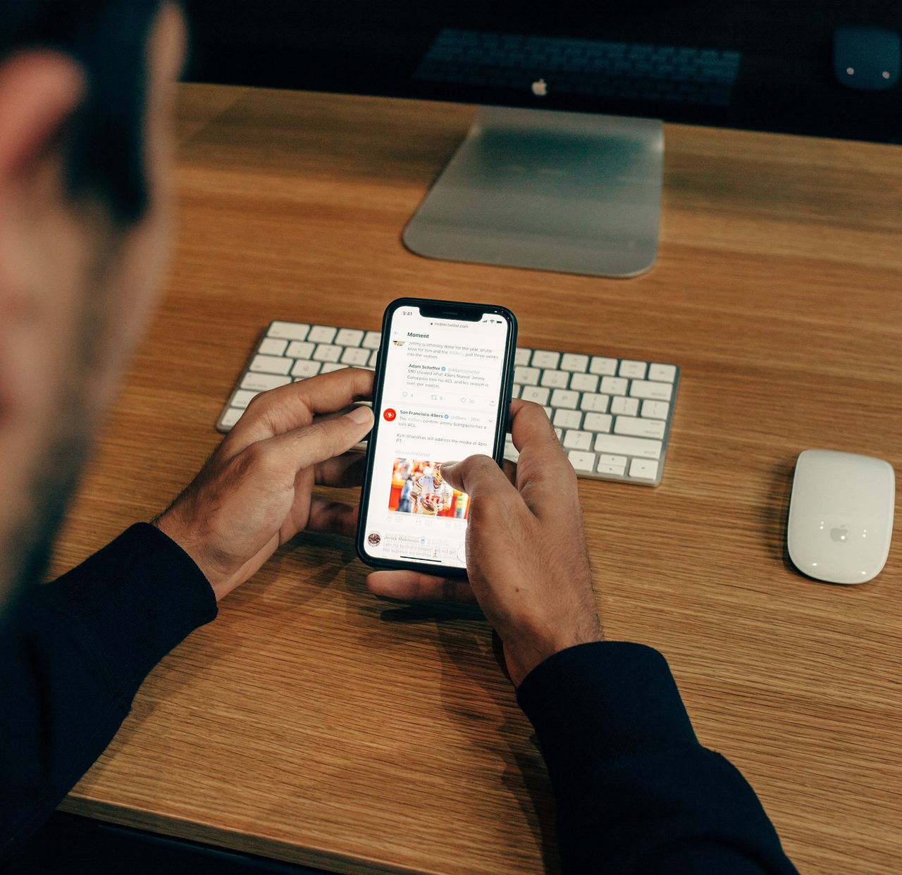 a man checking e-commerce email newsletter with his iphone