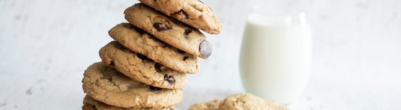 stacked cookies with a glass of milk