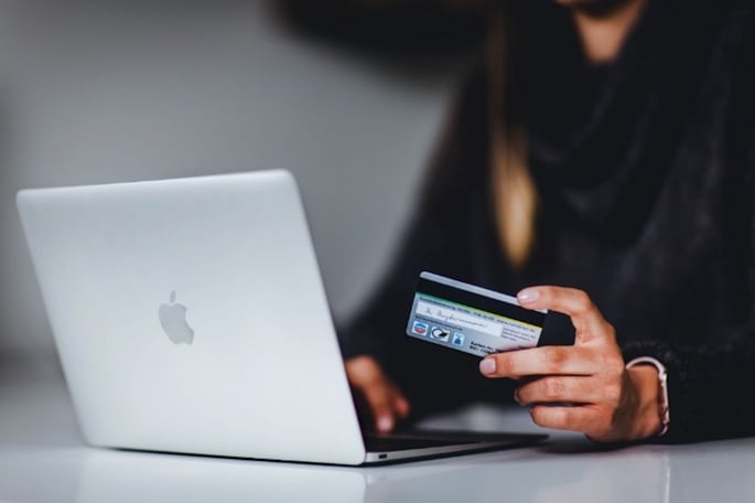 a person shopping online with a debit cart