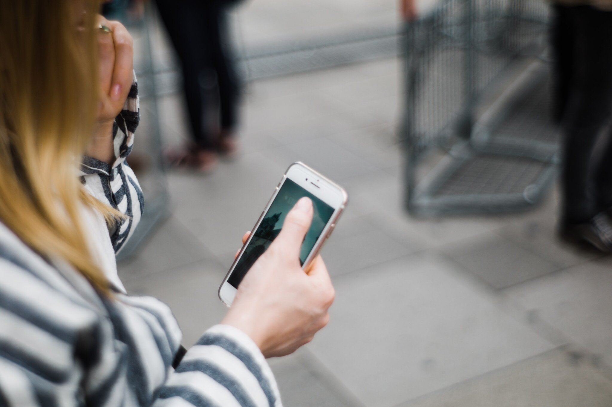 a woman checking her phone and a blurry background