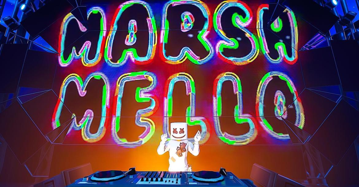 A screenshot from Marshmello's Fortnite concert where Marshmello's hands are up behind DJ set and Marshmello is written in a colorful-neon way on the screen behind