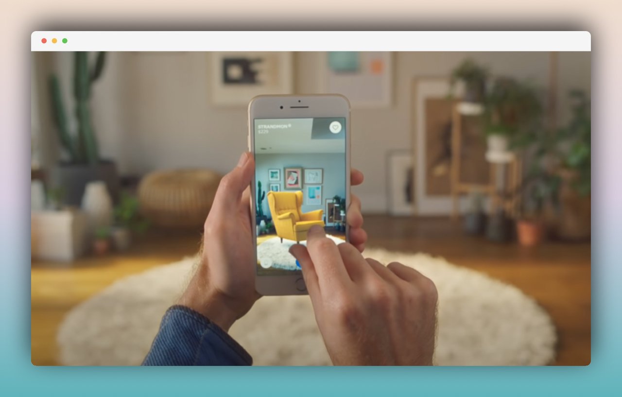 a screenshot from IKEA Place app where two hands are holding a phone in a living room trying a yellow armchair to see if it fits to room virtually