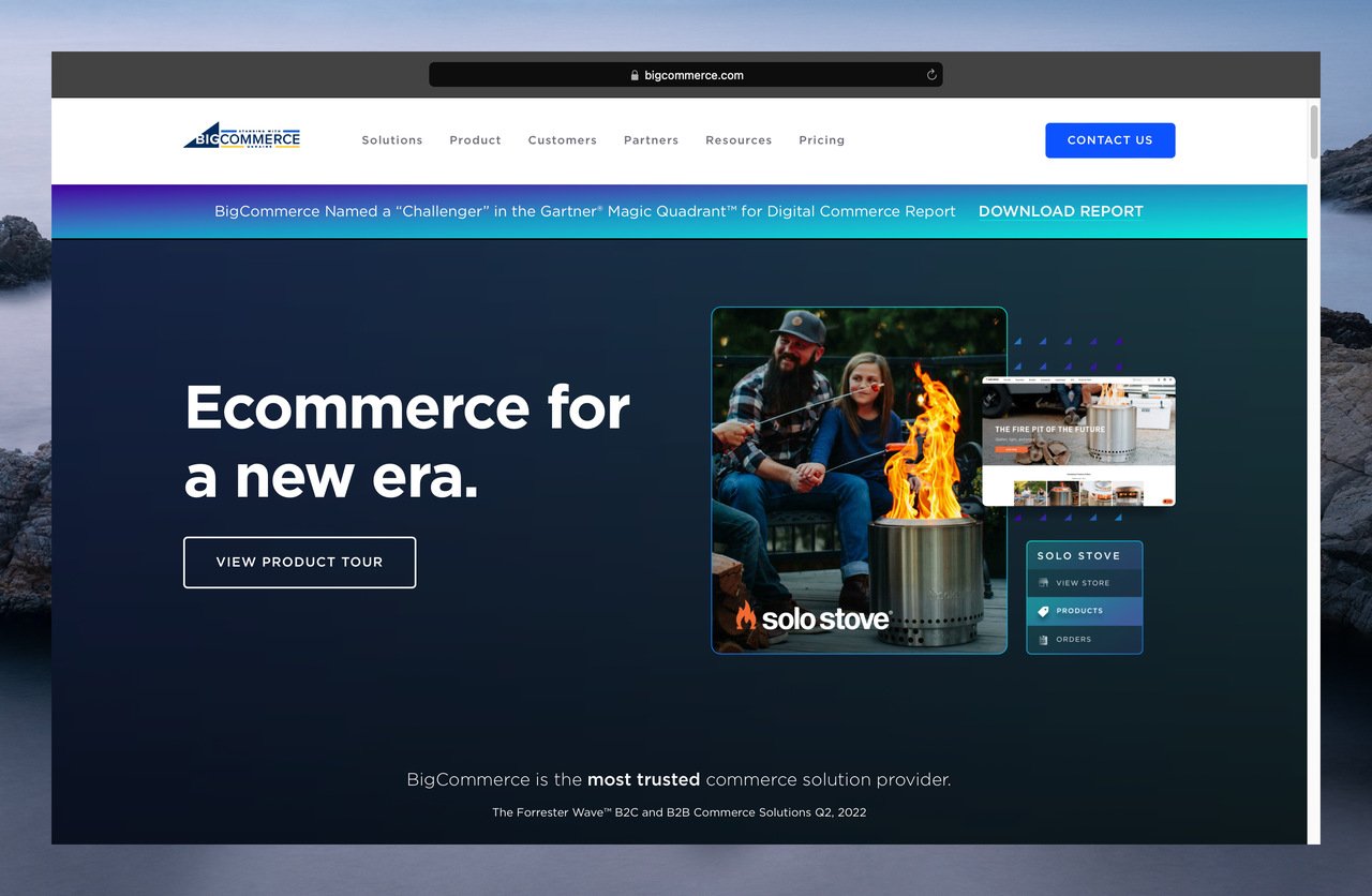 BigCommerce’s homepage with the title “Ecommerce for a new era.” on the left, and on the right there is a picture of a dad and daughter sitting by the fire, grilling sausages; two other mini panels as the ad of the fire stove