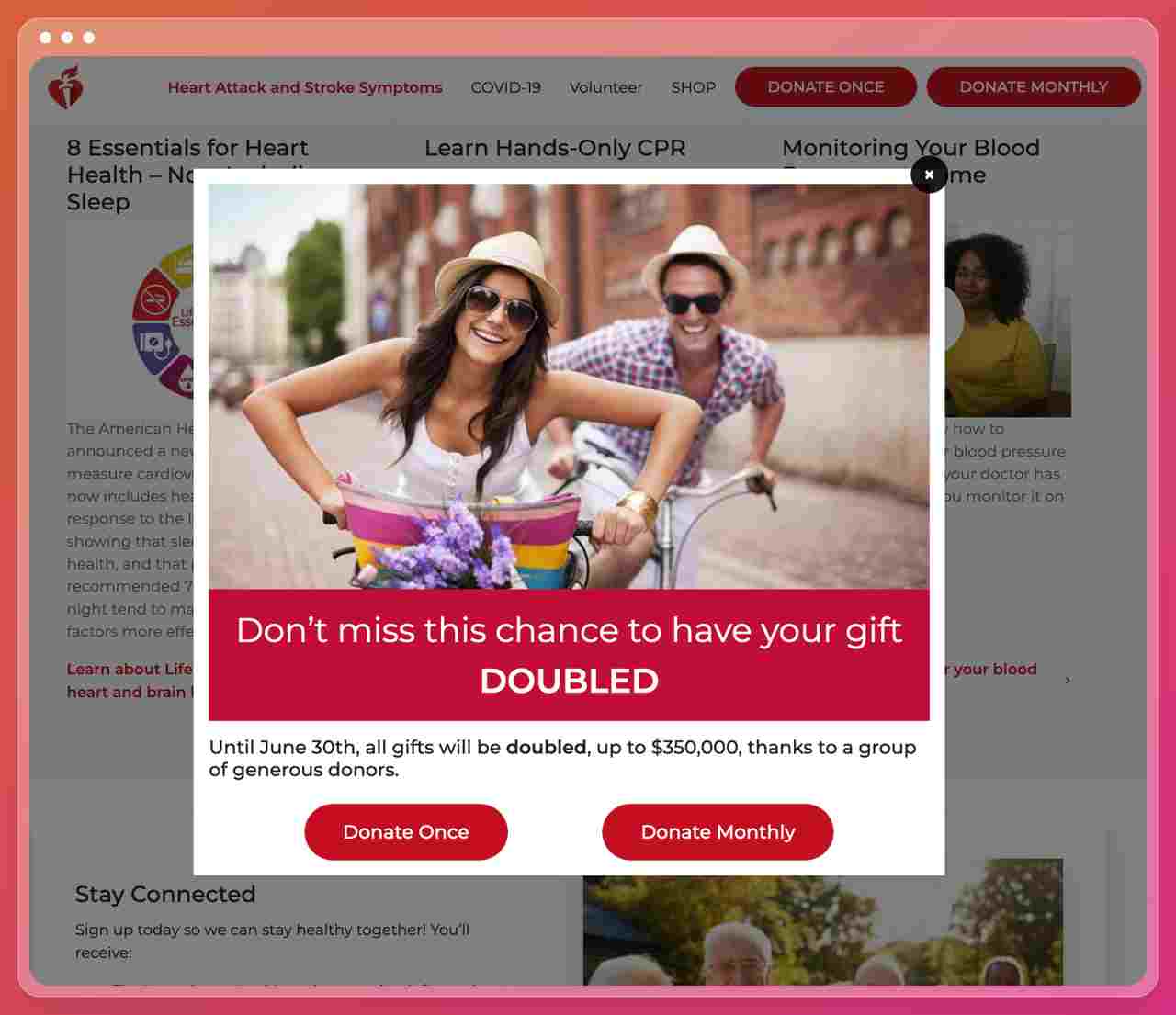 a screenshot of The American Heart Association nonprofit website showing a popup with a picture of a couple riding a bicycle