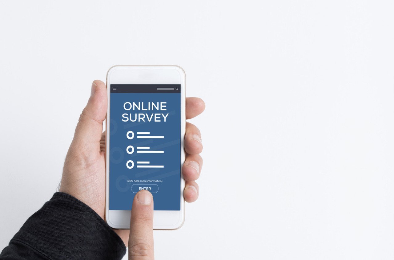 hands-holding-smartphone-filling-an-online-survey