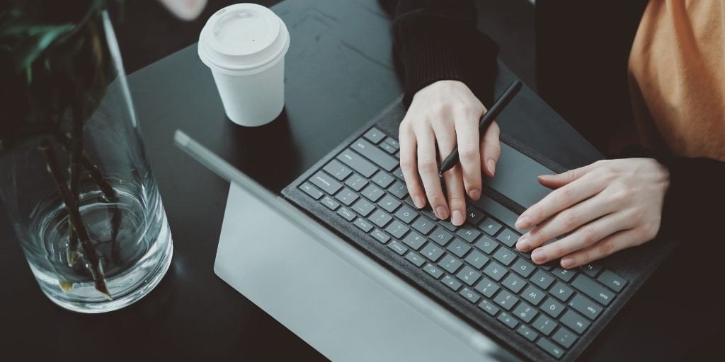 hands-typing-on-black-laptop