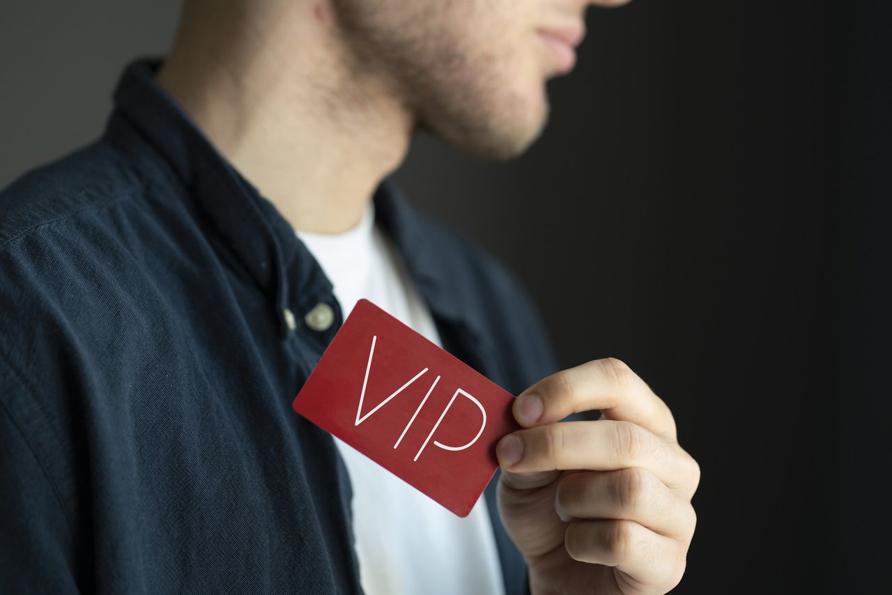 a man holding a VIP card