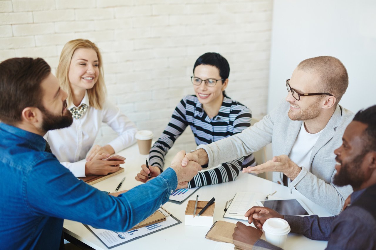 a group of people shaking their hands for their business