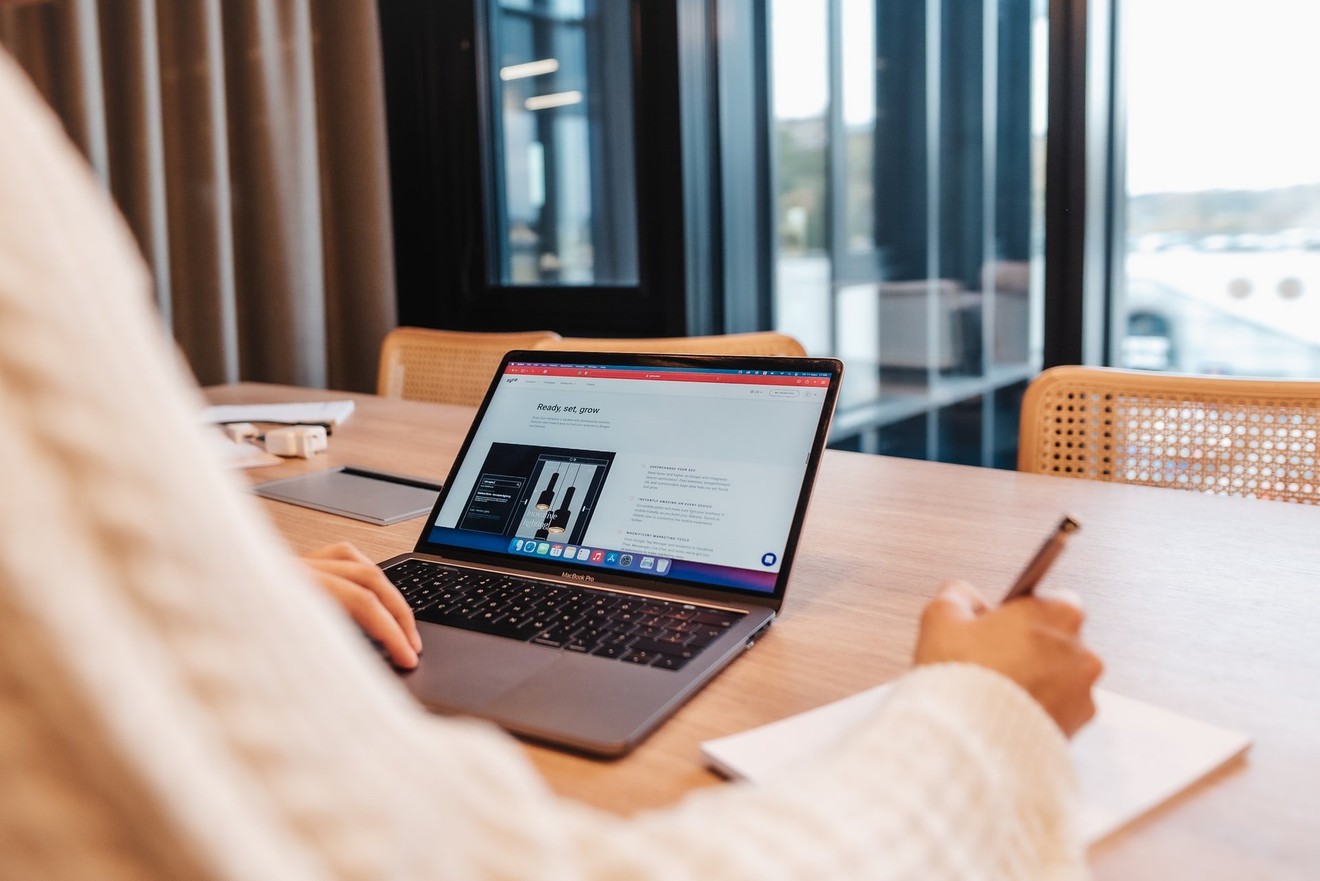 a man working with a laptop and viewing a zyro website