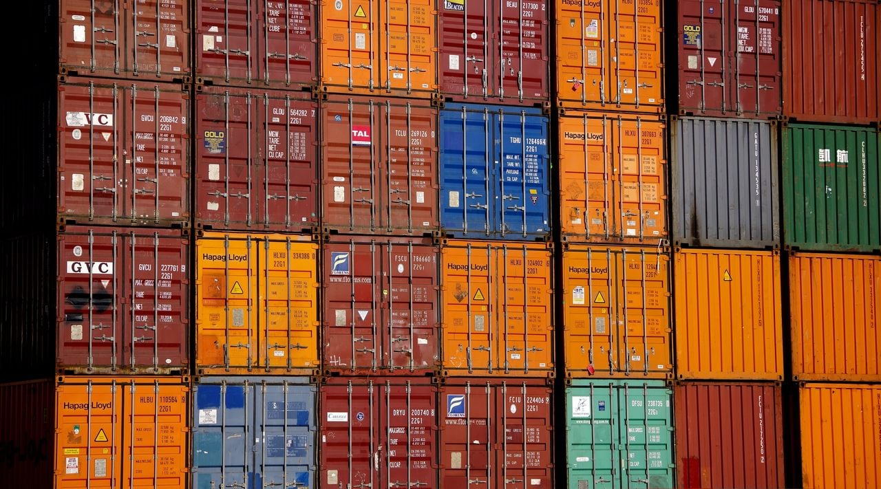 a stack of colorful containers which are being shipped