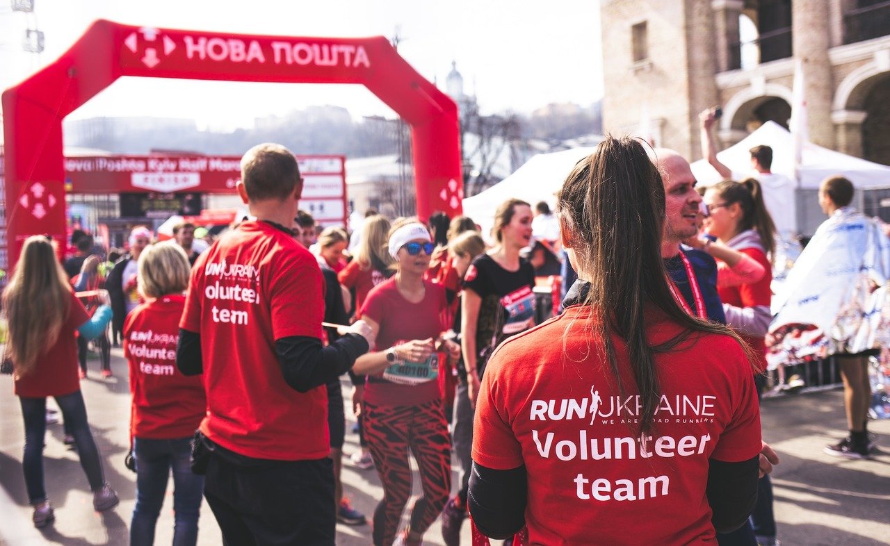 a crowd of people wearing res t-shirts on a volunteer event for Ukraine